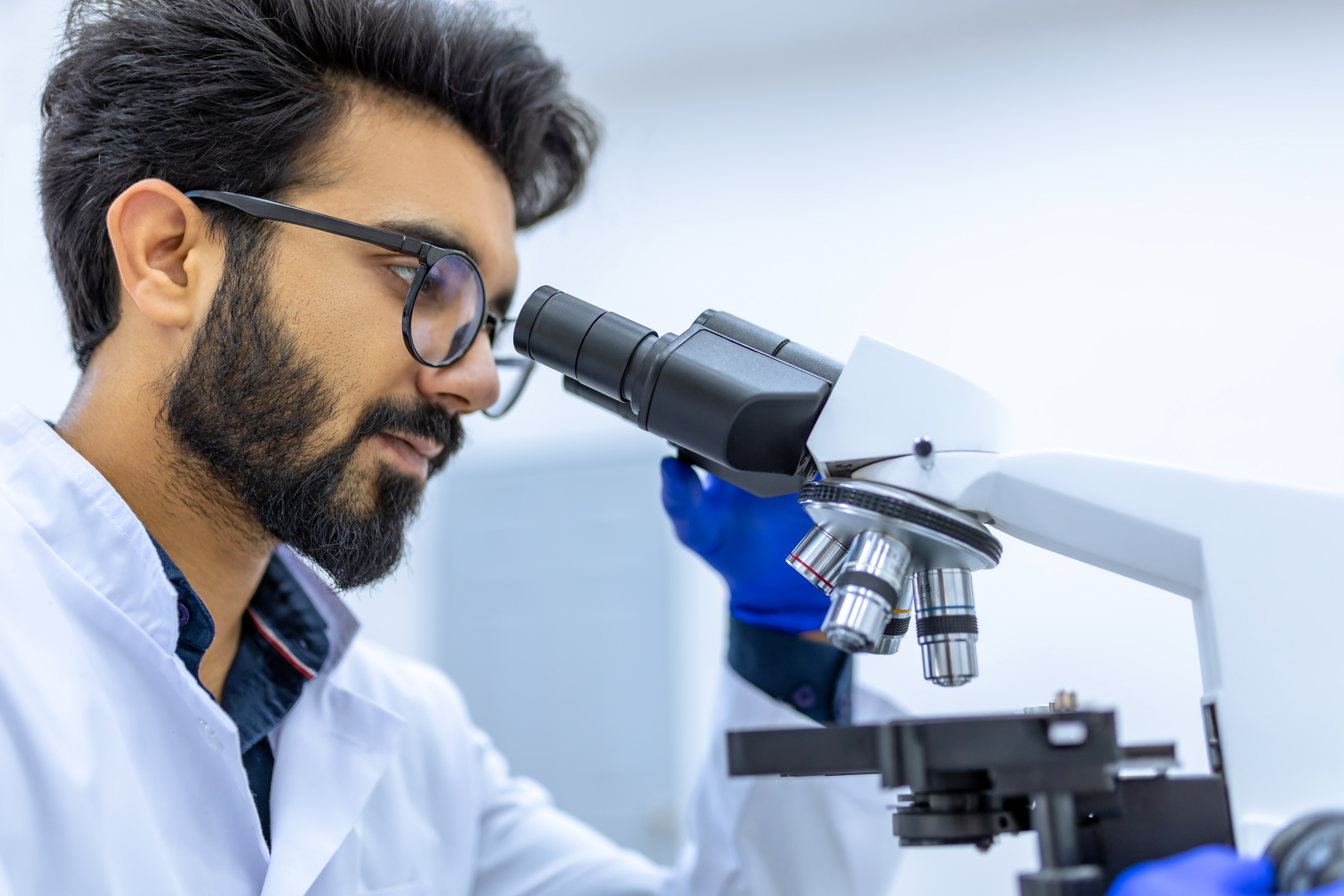 A man looking into a microscope