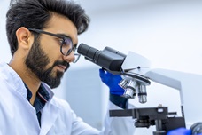 A man looking into a microscope