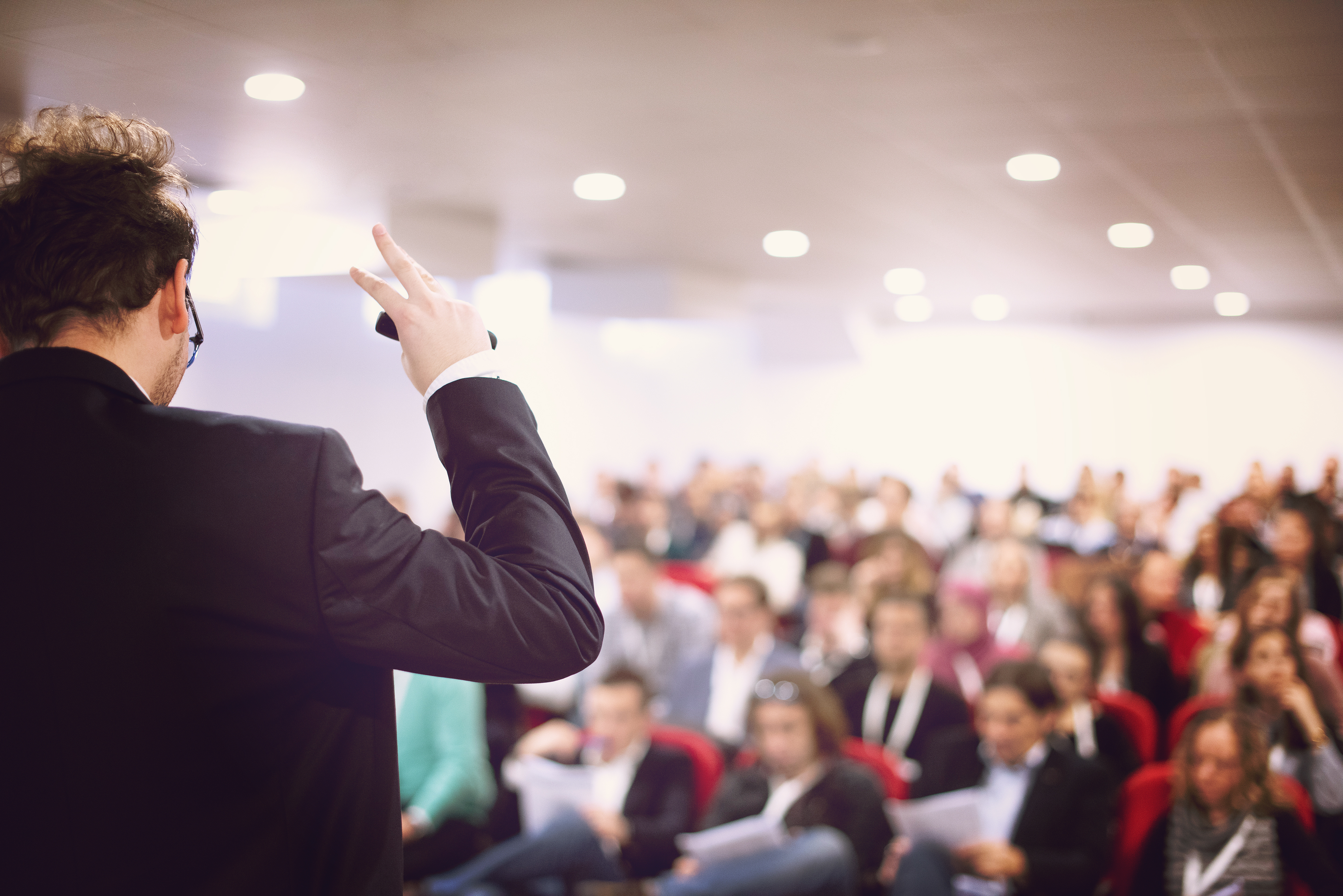 A man speaks at a conference