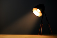 A spotlight casts a light on a desk.